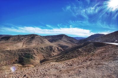 Scenic view of mountains against blue sky