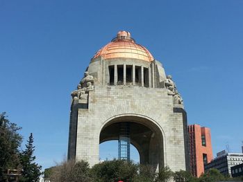 Low angle view of building against clear blue sky