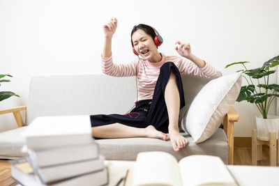 Portrait of happy family sitting on sofa at home