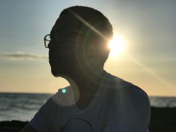 Portrait of man against sea during sunset