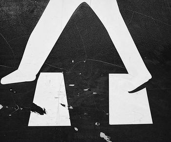 Close-up of arrow sign on wall