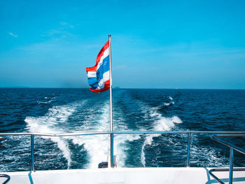 Sailboat sailing on sea against sky