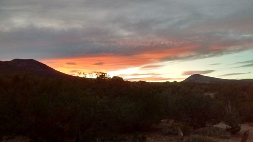 Scenic view of silhouette mountains against sky at sunset