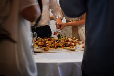 Midsection of man preparing food on table