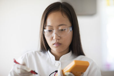 Scientist female with sample and tool in a lab