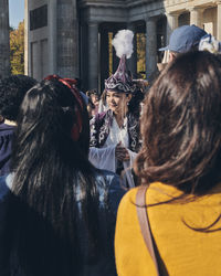 Rear view of people walking in town square