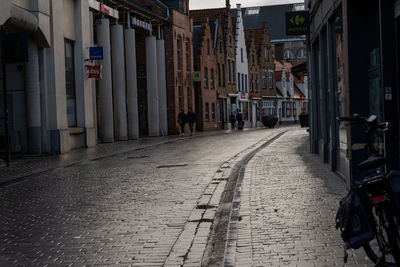 Empty alley amidst buildings in city
