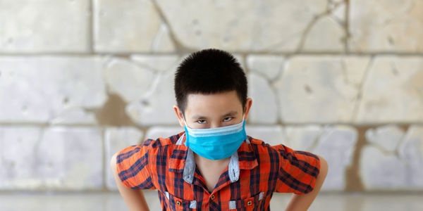 Portrait of boy against wall