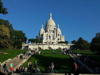 People in front of basilique du sacre coeur against clear sky