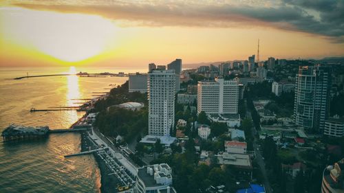 High angle view of buildings in city during sunset