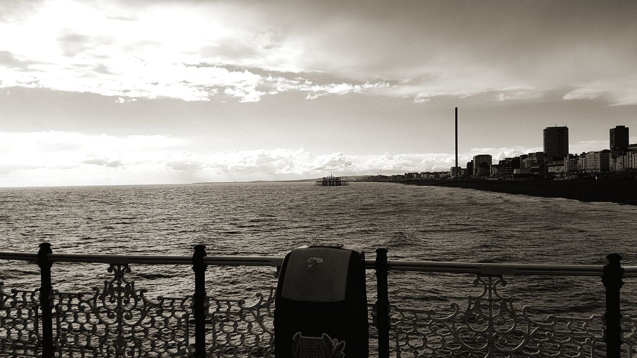 SCENIC VIEW OF SEA AGAINST SKY SEEN FROM FENCE