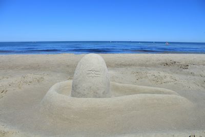 Scenic view of beach against clear sky