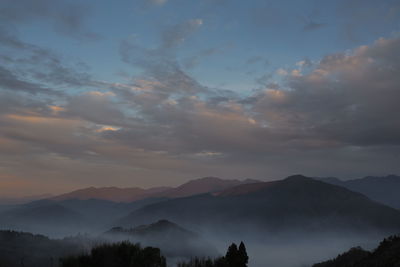 Scenic view of silhouette mountains against sky during sunset