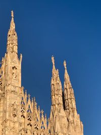 Low angle view of temple building against clear blue sky