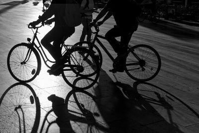 Low section of people riding bicycle on street