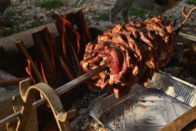 High angle view of meat on barbecue grill