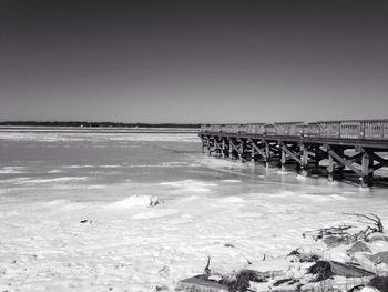 Pier over sea against clear sky