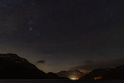 Scenic view of mountains against sky at night