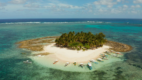 Sandy beach on a small island by coral reef atoll from above. guyam island, philippines, siargao. 