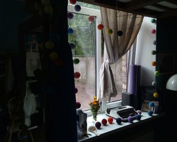 Clothes hanging on table by window at home