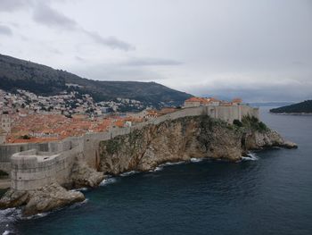 Scenic view of river against cloudy sky