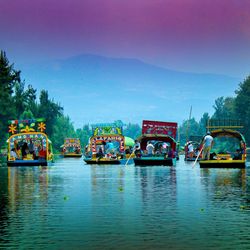 Boats in river against sky