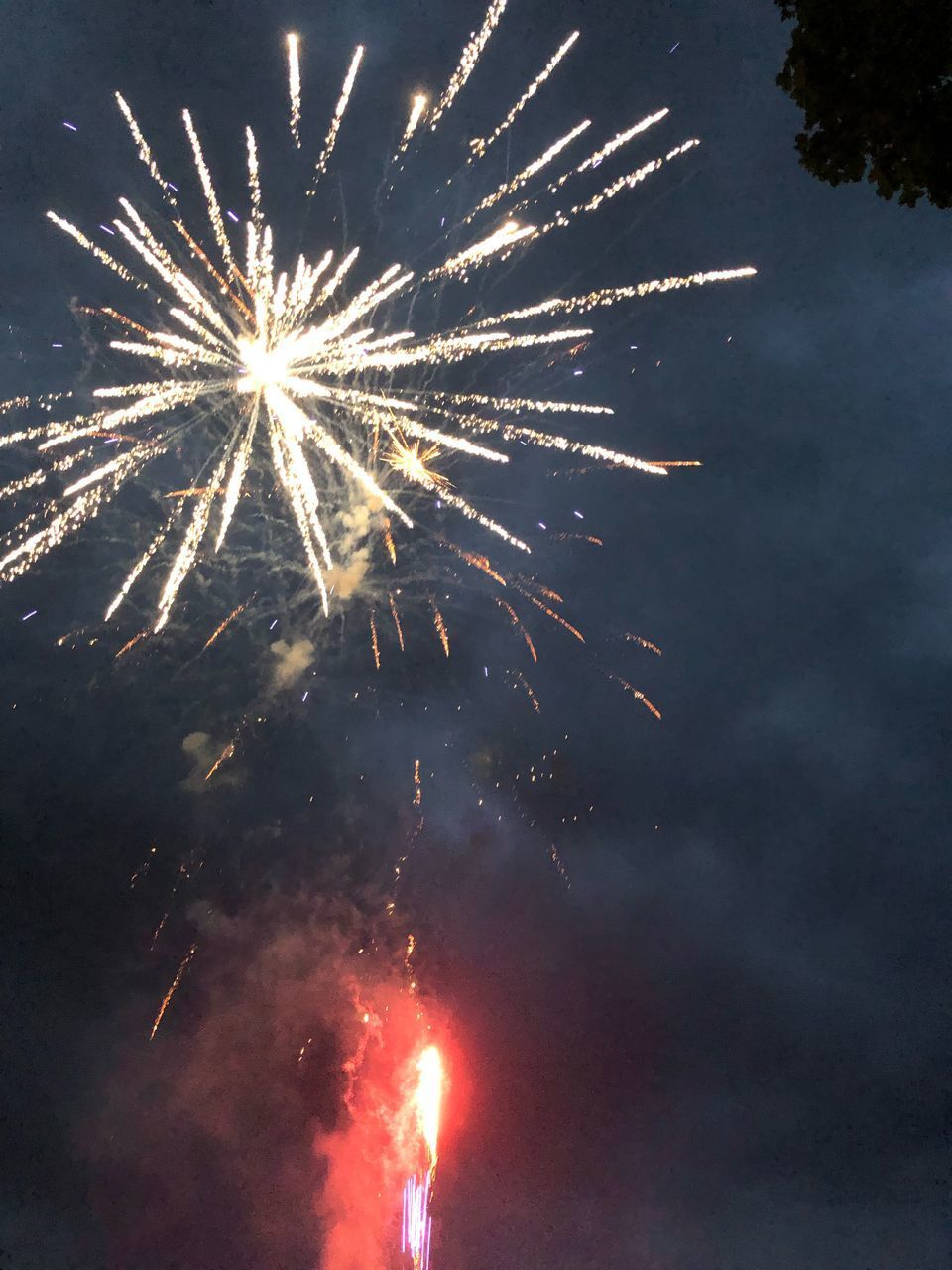 LOW ANGLE VIEW OF FIREWORKS IN SKY