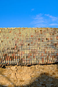 Brick wall against blue sky