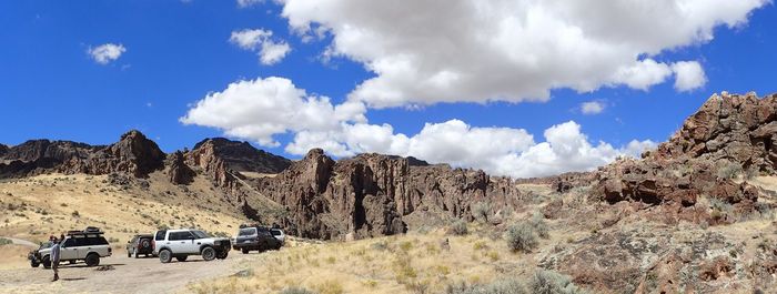 Scenic view of mountains against blue sky