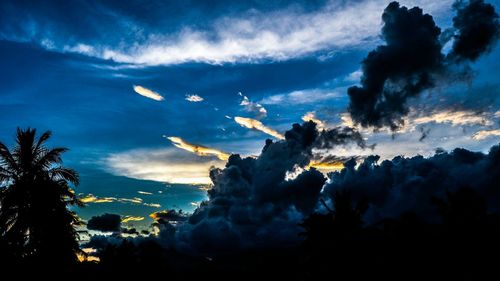 Scenic view of mountains against cloudy sky