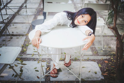 Portrait of a girl sitting on white background