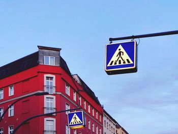 Low angle view of road sign against sky