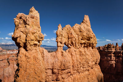 View of rock formations against blue sky