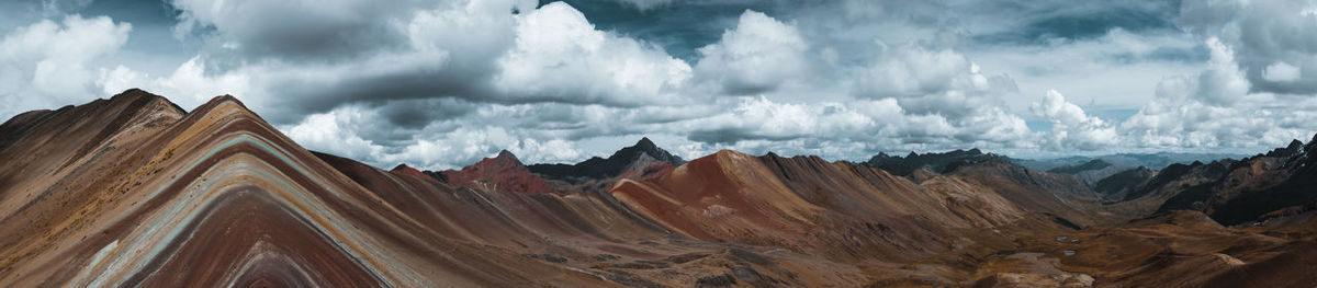 Panoramic view of mountains against cloudy sky