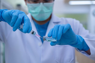 Midsection of man holding umbrella