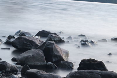 Rocks on beach against sky