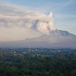 Scenic view of volcano against cloudy sky