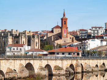 View of arch bridge and buildings against sky