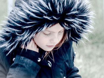 Close-up of girl wearing fur coat