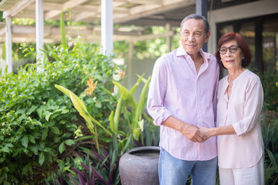 Portrait of cheerful couple standing outdoors