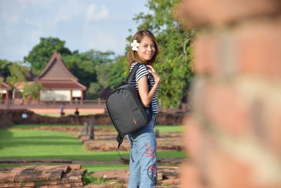 Portrait of smiling woman standing in city