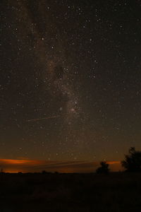 Scenic view of silhouette landscape against star field at night