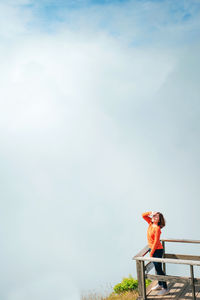 Woman standing against sky