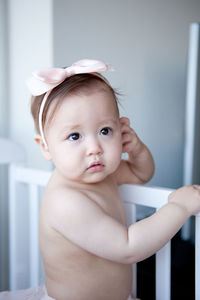 Close-up of cute shirtless baby girl wearing headband