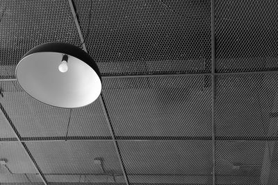 Low angle view of illuminated pendant lights hanging from ceiling