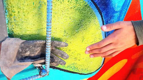 High angle view of woman holding multi colored umbrella