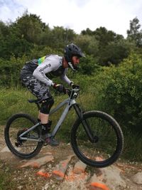 Man riding bicycle on field