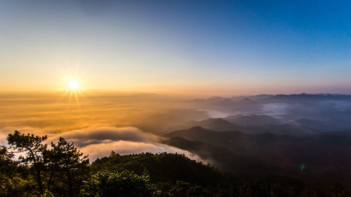 Scenic view of silhouette mountains against sky at sunset