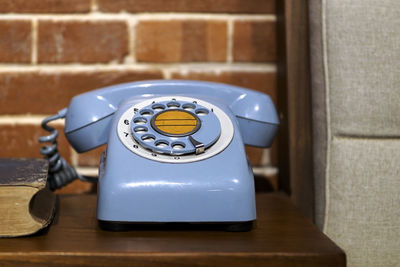 Close-up of telephone on wooden table