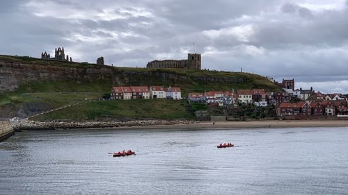Scenic view of sea and buildings against sky